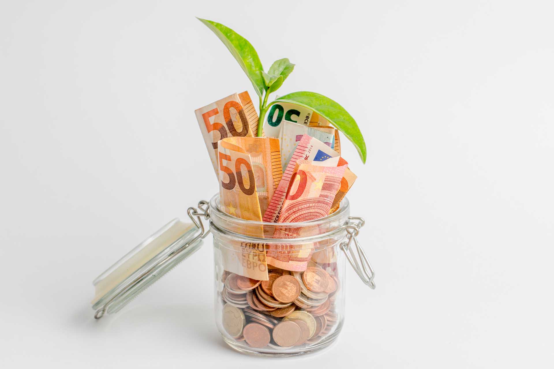 Coins,And,Bills,In,A,Glass,Jar,Isolated,On,White,